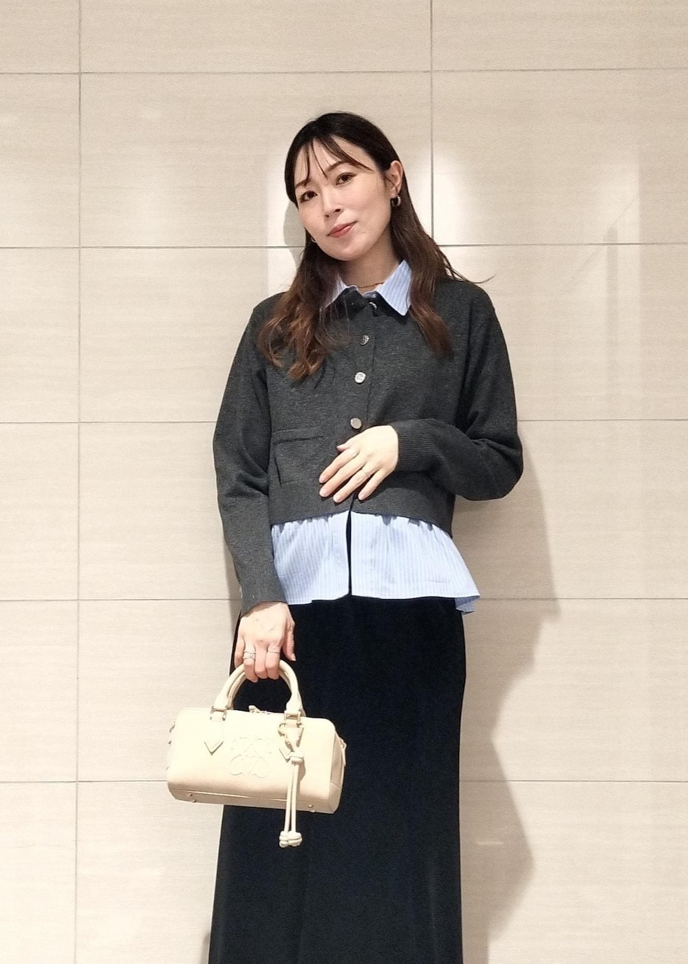 ベージュ系のボストンバッグ、ブラック系のブーツ、ブラウン系のキャミソールを着用したレディースの秋コーディネートの8枚目の写真