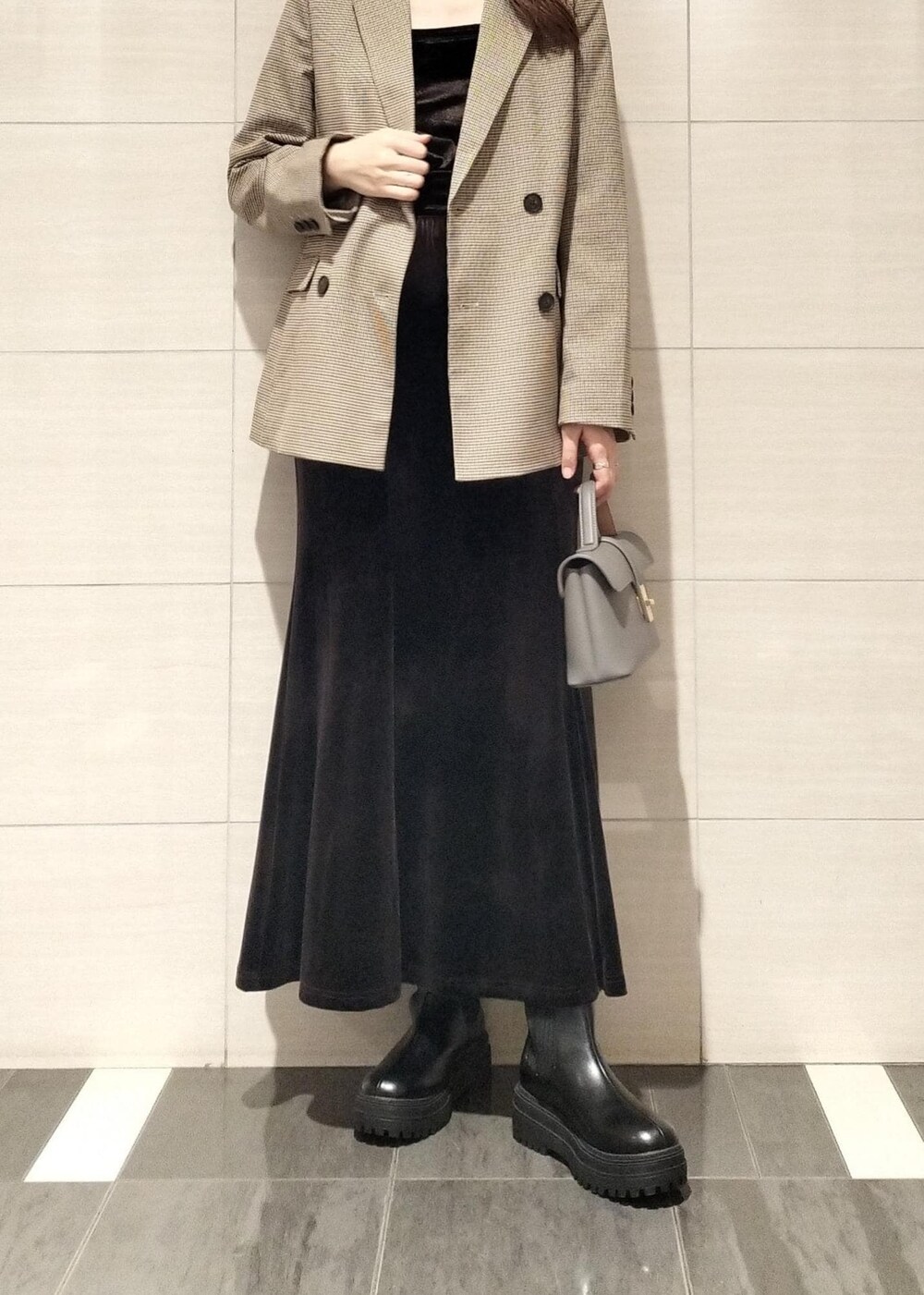 グレー系のショルダーバッグ、ベージュ系のテーラードジャケット、ブラック系のブーツを着用したレディースの秋コーディネートの7枚目の写真