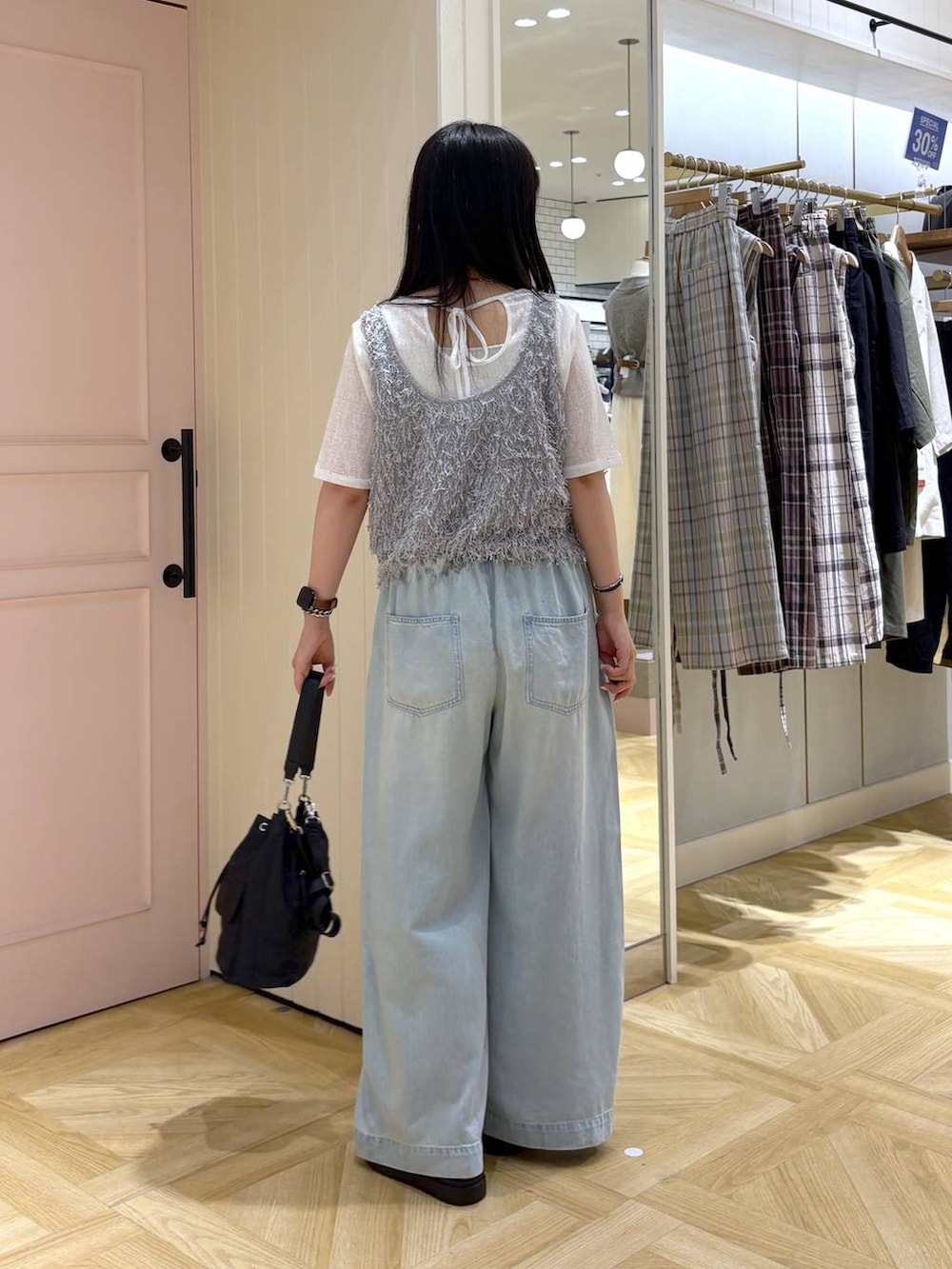 ホワイト系のTシャツ/カットソー、シルバー系のサンダル、グレー系のベストを着用したレディースの夏コーディネートの4枚目の写真