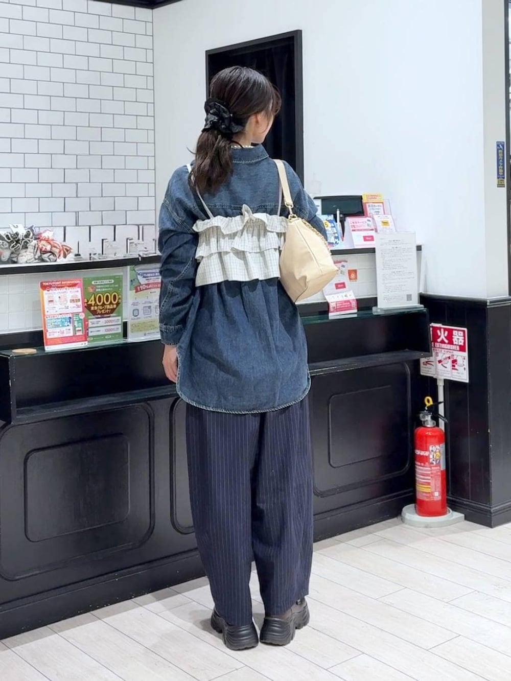 ブルー系のその他パンツ、ブルー系のシャツ/ブラウス、ベージュ系のショルダーバッグを着用したレディースの冬コーディネートの3枚目の写真