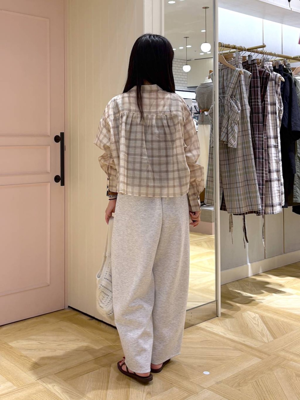 グレー系のスウェットパンツ、シルバー系のタンクトップ、ベージュ系のシャツ/ブラウスを着用したレディースの夏コーディネートの4枚目の写真