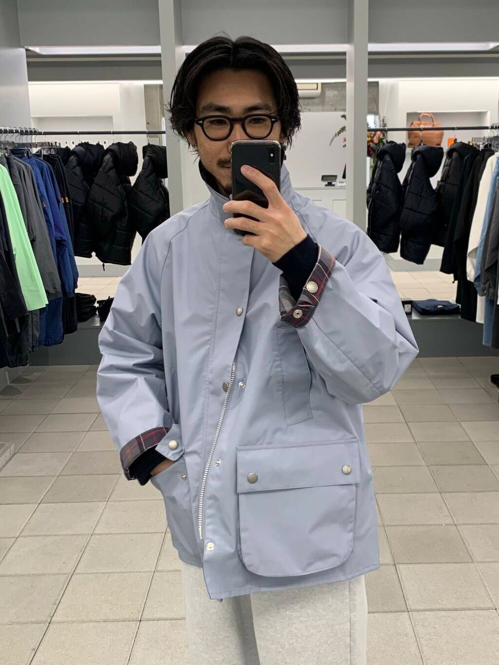 ブルー系のナイロンジャケット、グレー系のスウェットパンツ、ブルー系のニット/セーターを着用したメンズの冬コーディネートの5枚目の写真