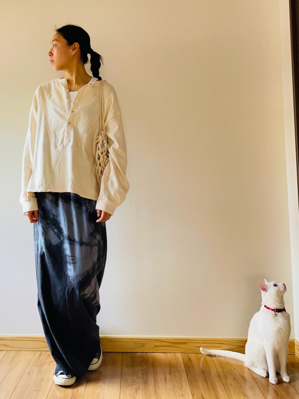 ベージュ系のトップス、グレー系のワンピース、ホワイト系のトートバッグを着用したレディースの春コーディネートの2枚目の写真