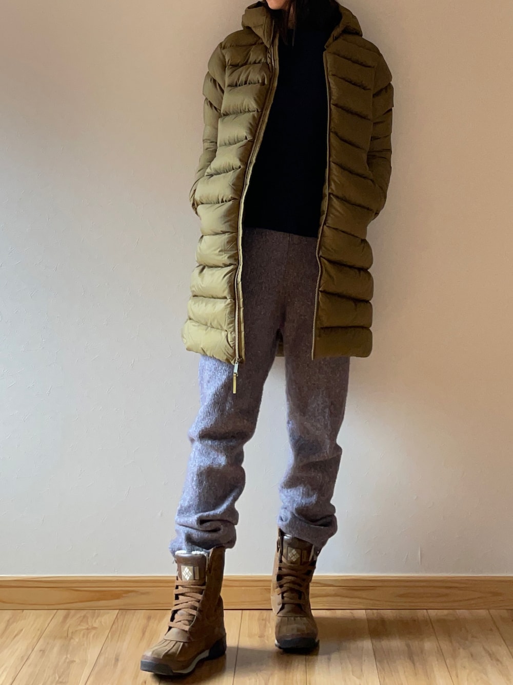 グリーン系のダウンジャケット/コート、ブルー系のニット/セーター、グレー系のその他パンツを着用したレディースの冬コーディネートの4枚目の写真