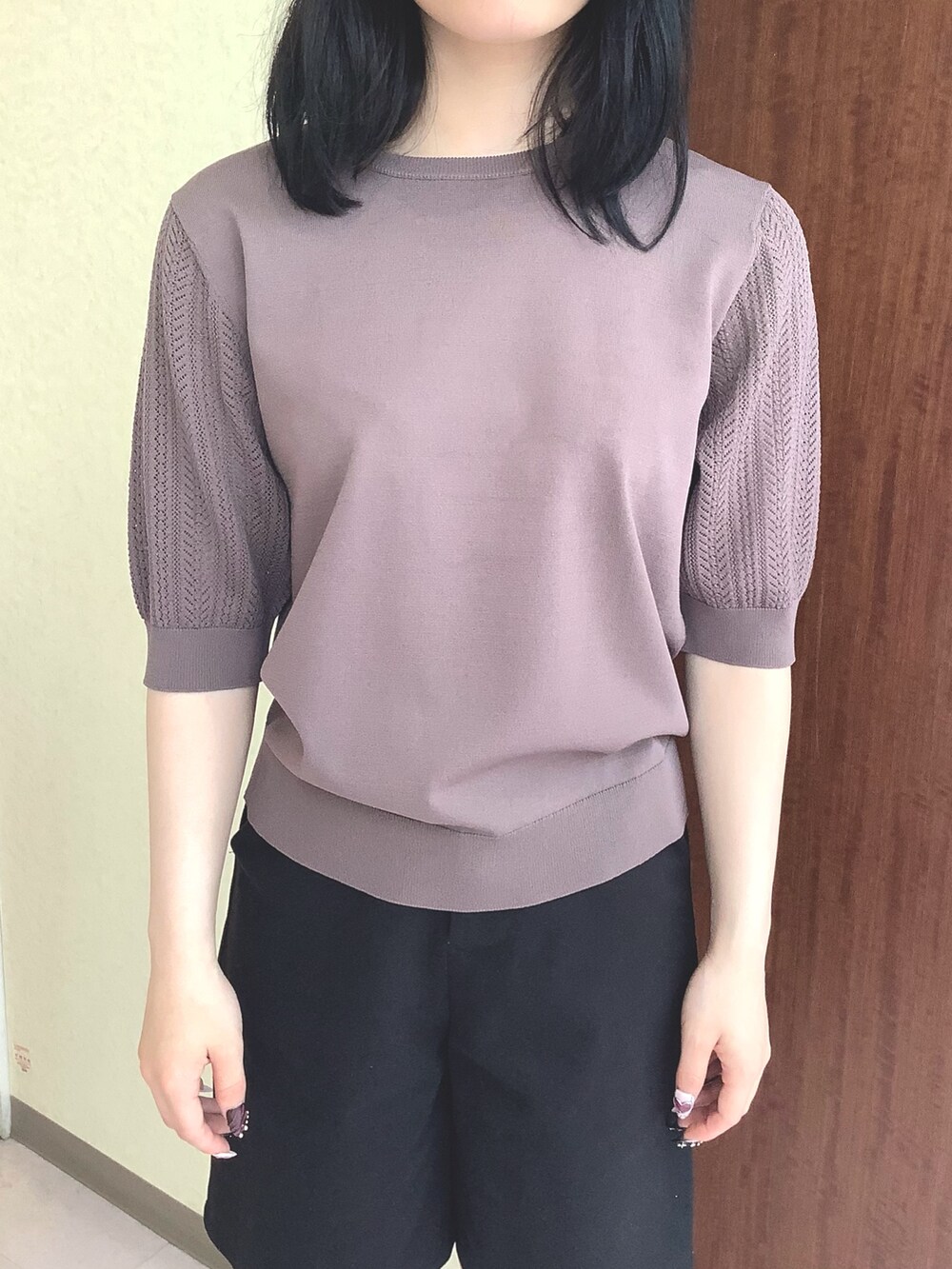 ブラウン系のニット/セーターを着用したレディースの夏コーディネートの2枚目の写真