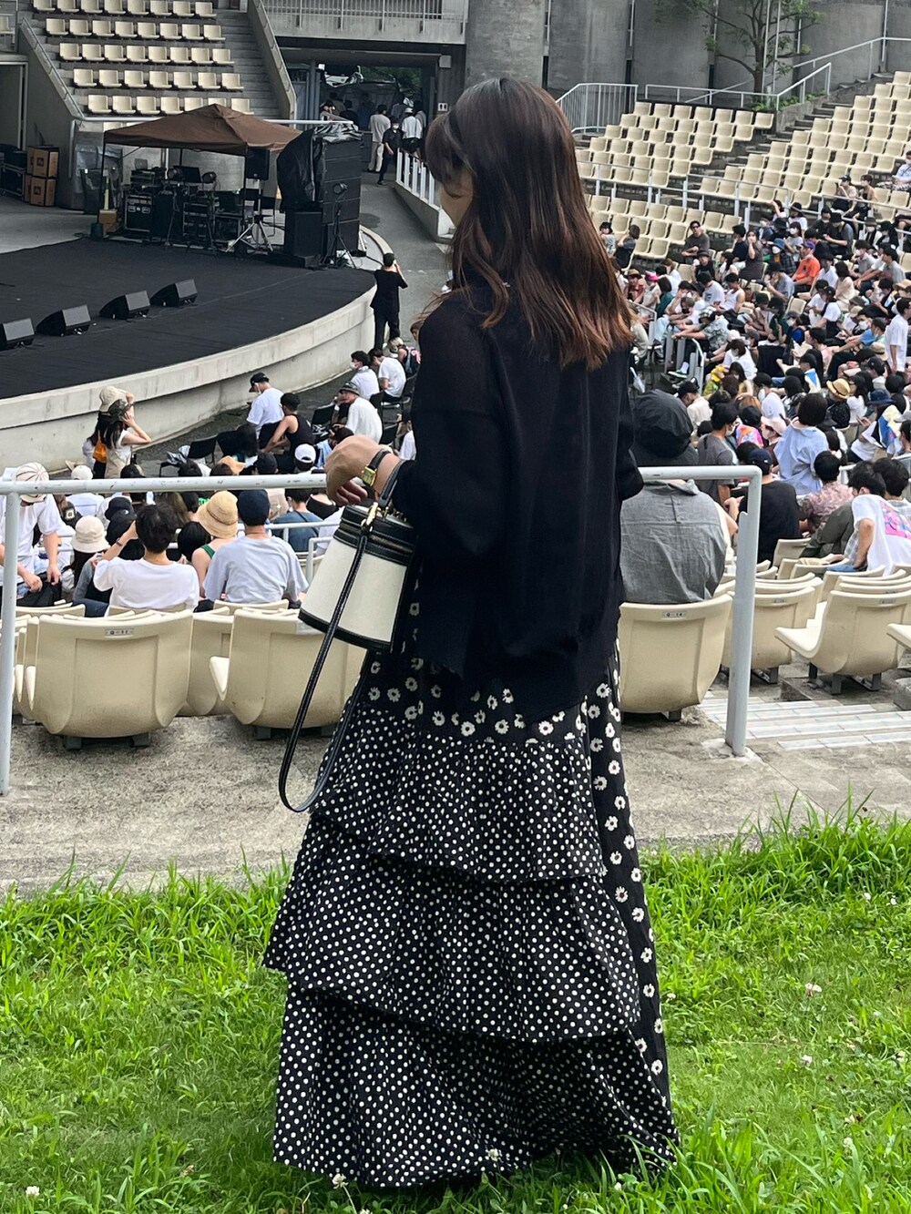 ホワイト系のハンドバッグ、ブラウン系のサンダル、ブラック系のワンピース/ドレスを着用したレディースの夏コーディネートの2枚目の写真