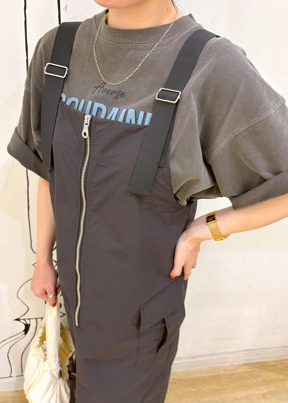 ブラック系のサンダル、グレー系のジャンパースカート、グレー系のTシャツ/カットソーを着用したレディースの夏コーディネートの5枚目の写真