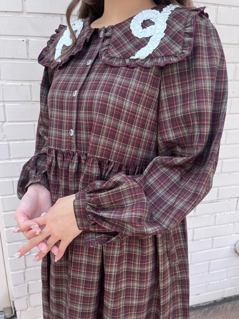 レッド系のワンピース、ホワイト系のサンダルを着用したレディースの秋コーディネートの6枚目の写真