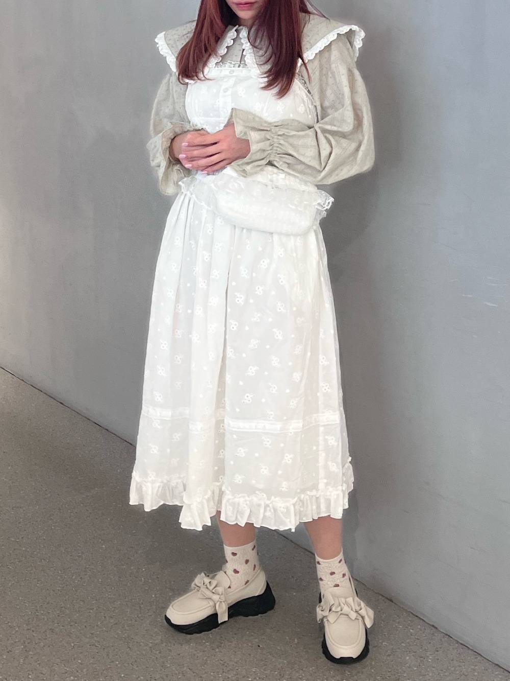 ホワイト系のワンピース、グリーン系のシャツ/ブラウス、ホワイト系のスニーカーを着用したレディースの春コーディネートの2枚目の写真