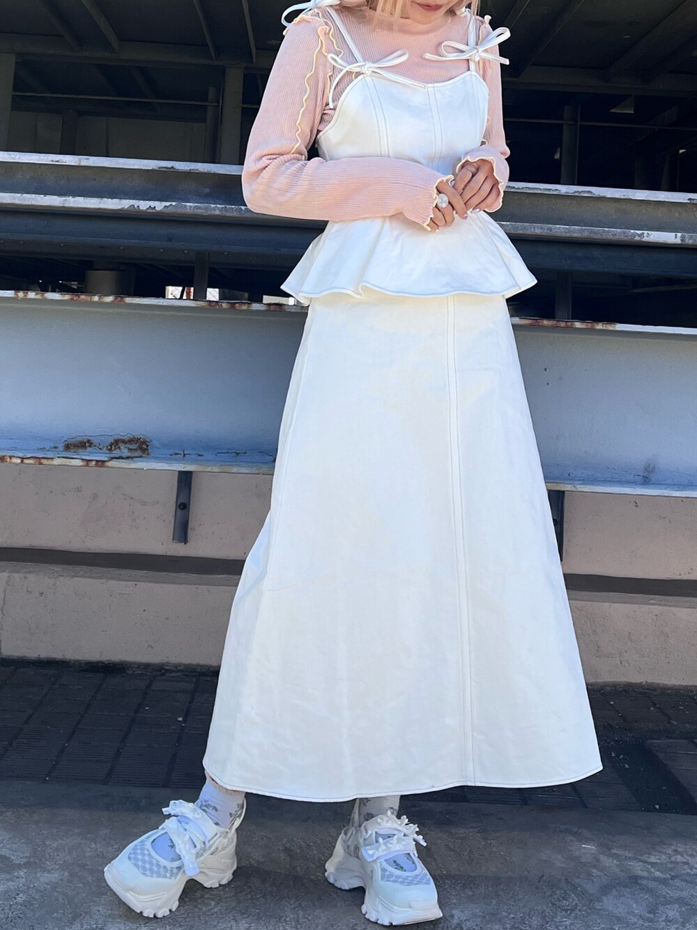 ピンク系のTシャツ/カットソー、ホワイト系のワンピース、ホワイト系のスニーカーを着用したレディースの冬コーディネートの2枚目の写真