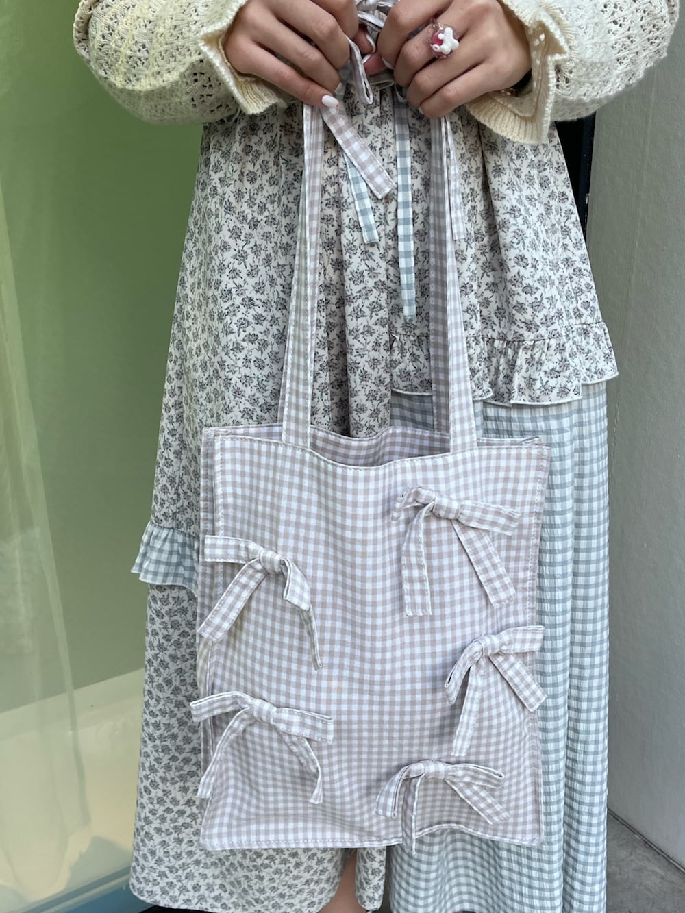 ホワイト系のカーディガン/ボレロ、ブルー系のスニーカー、ブルー系のワンピースを着用したレディースの春コーディネートの9枚目の写真