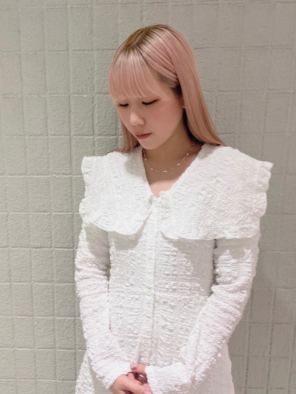 ホワイト系のワンピース、ピンク系のパンプスを着用したレディースの春コーディネートの4枚目の写真