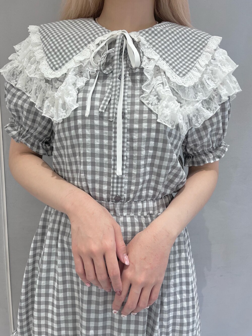 グレー系のシャツ/ブラウス、グレー系のスカート、ホワイト系のサンダルを着用したレディースの春コーディネートの5枚目の写真