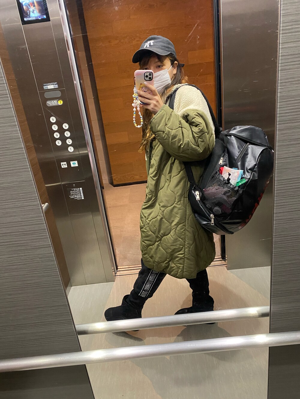 ブラック系のスウェットパンツ、ブラック系のキャップを着用したレディースの冬コーディネートの2枚目の写真