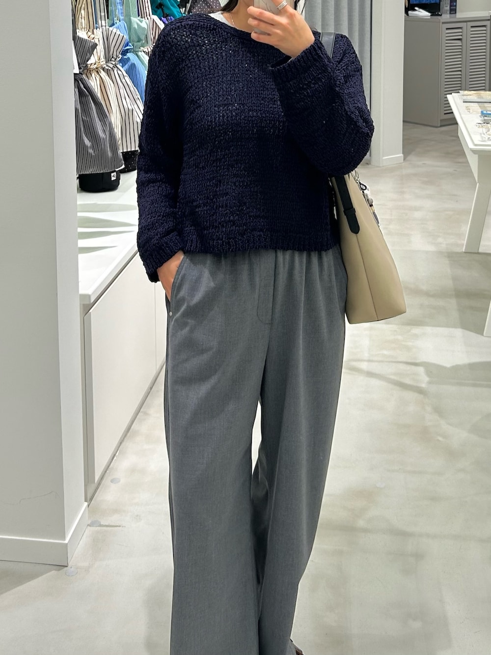 ブルー系のニット/セーター、グレー系のTシャツ/カットソー、グレー系のその他パンツを着用したレディースの春コーディネートの3枚目の写真