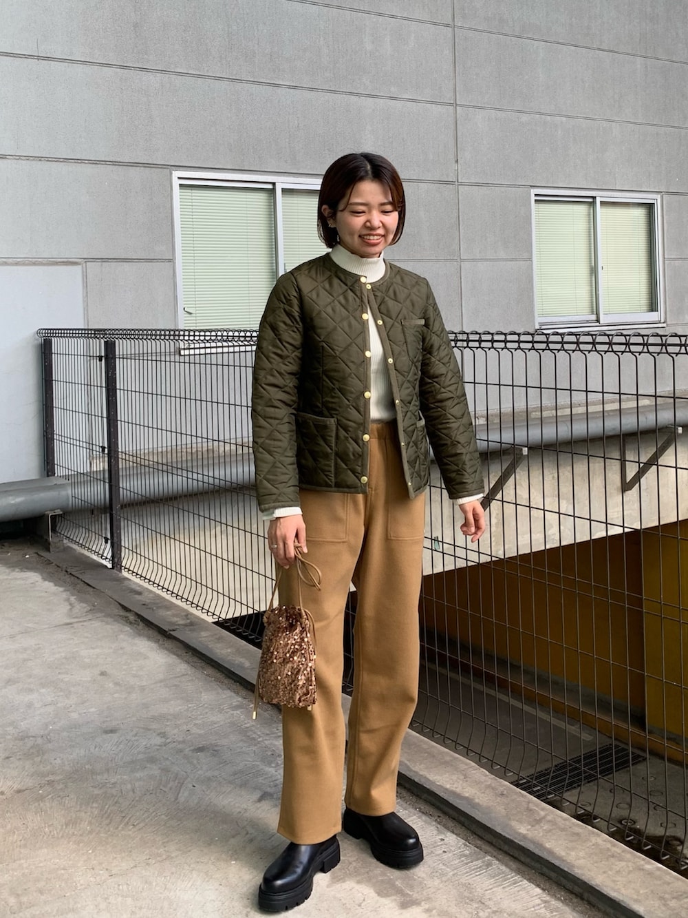 グリーン系のブルゾン、ブラウン系のその他パンツ、ブラック系のブーツを着用したレディースの秋コーディネートの4枚目の写真