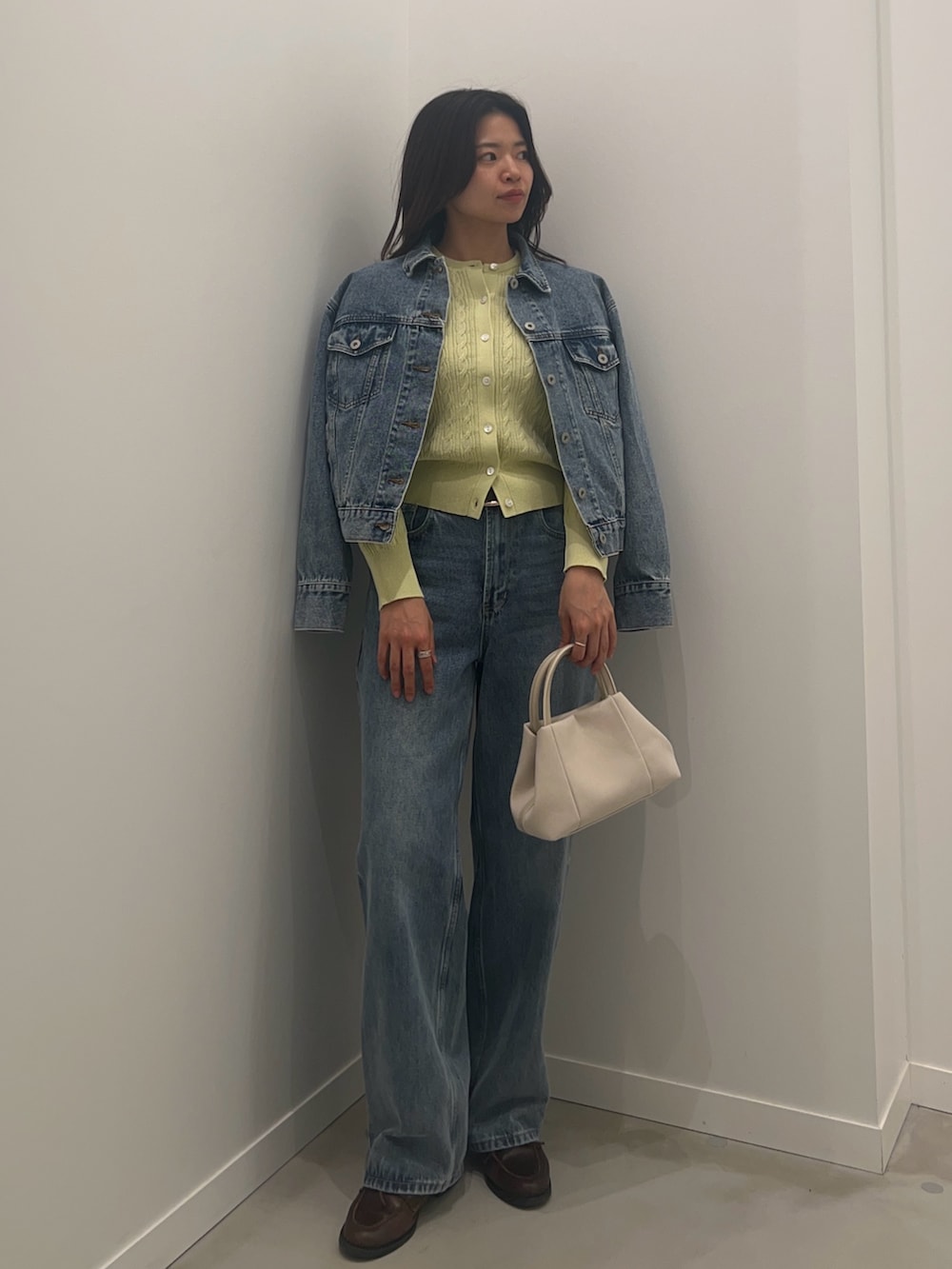 ブルー系のデニムパンツ、ブルー系のデニムジャケット、グリーン系のカーディガン/ボレロを着用したレディースの冬コーディネートの4枚目の写真