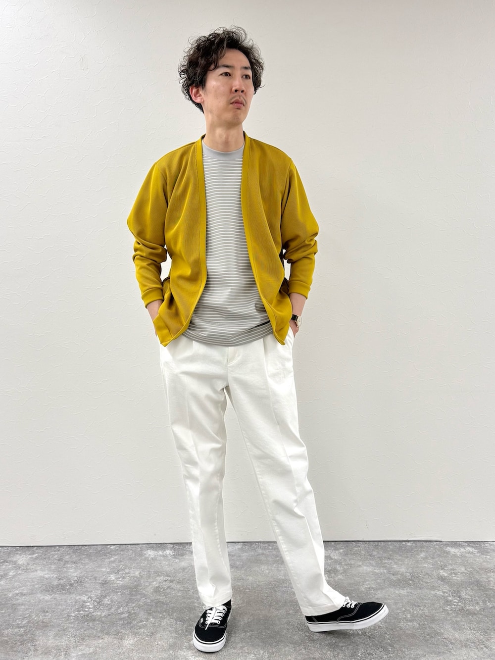 イエロー系のカーディガン/ボレロ、グレー系のTシャツ/カットソー、ホワイト系のデニムパンツを着用したメンズの春コーディネートの2枚目の写真