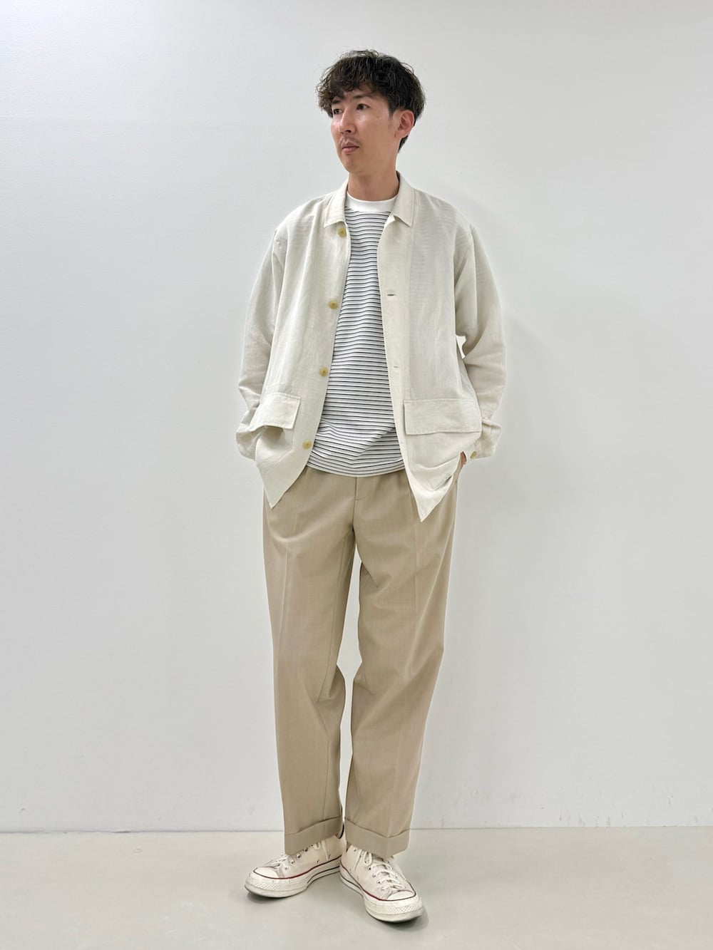 ホワイト系のシャツ/ブラウス、ベージュ系のスラックス、ホワイト系のTシャツ/カットソーを着用したメンズの夏コーディネートの2枚目の写真