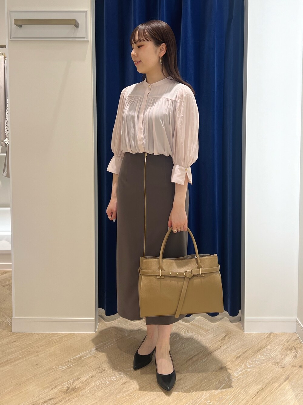 ブラウン系のスカート、ピンク系のシャツ/ブラウス、ブラック系のトートバッグを着用したレディースの春コーディネートの2枚目の写真