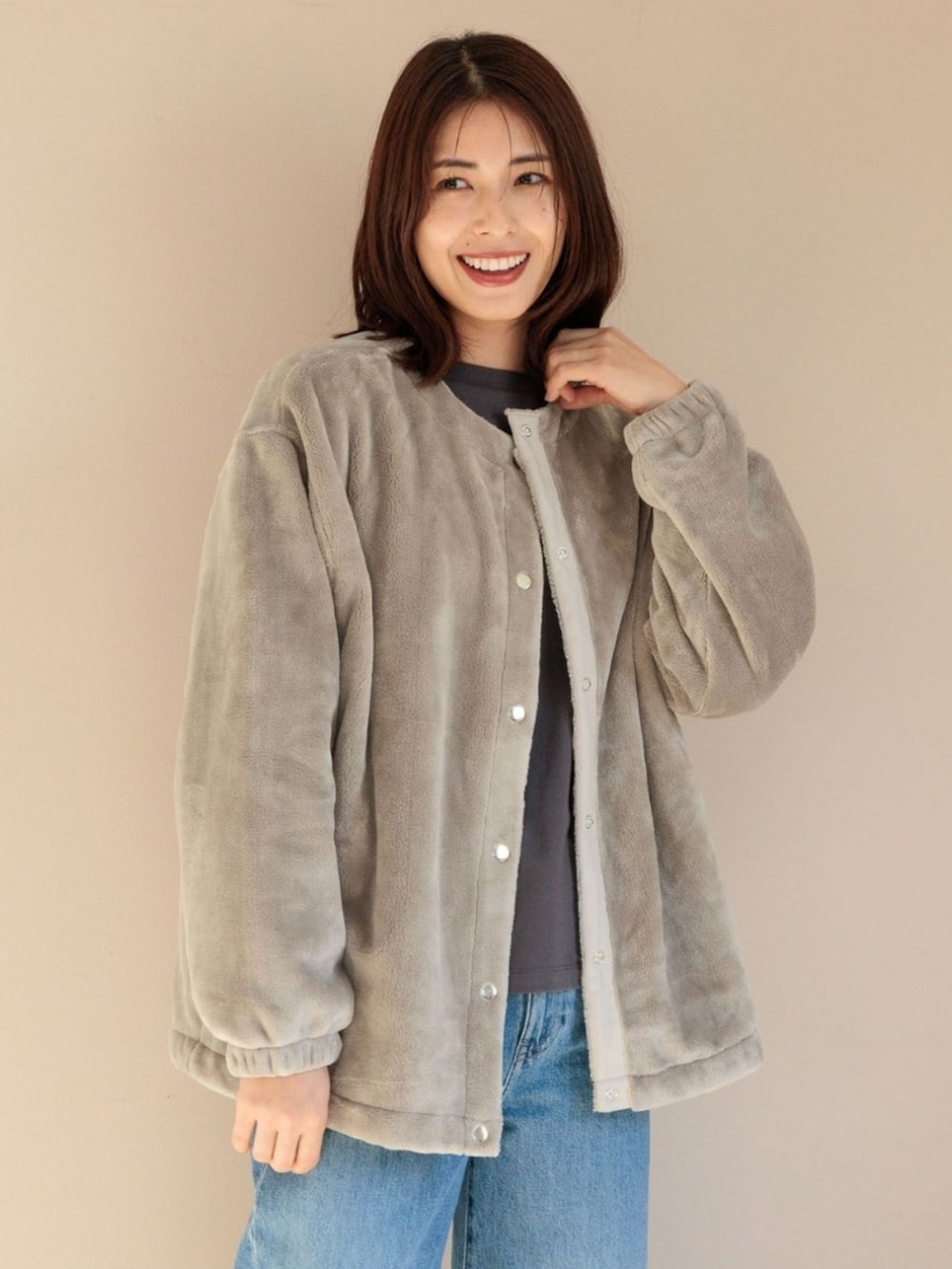 ベージュ系のブルゾンを着用したレディースの冬コーディネートの2枚目の写真