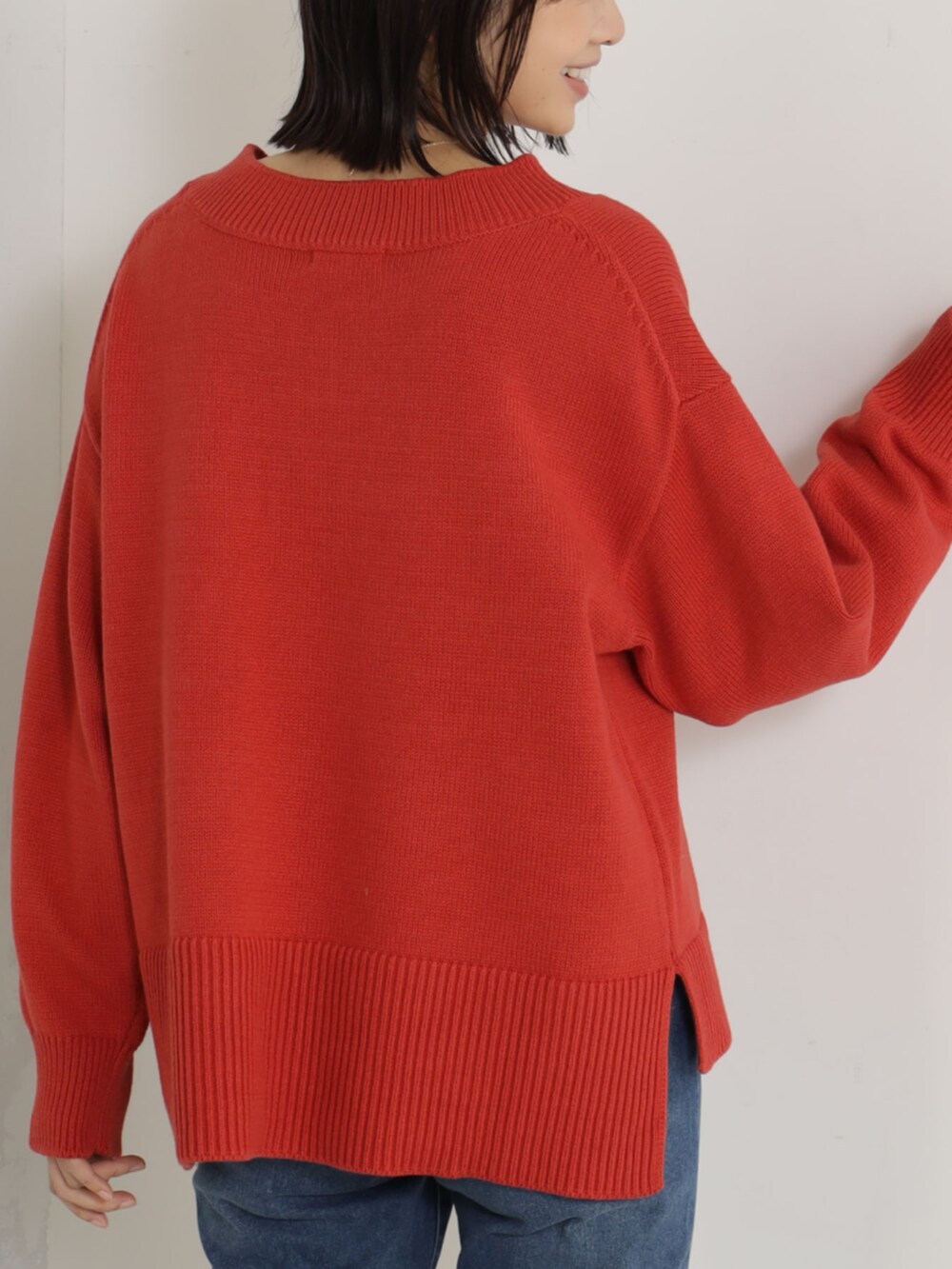 レッド系のニット/セーター、ブルー系のその他パンツを着用したレディースの冬コーディネートの3枚目の写真