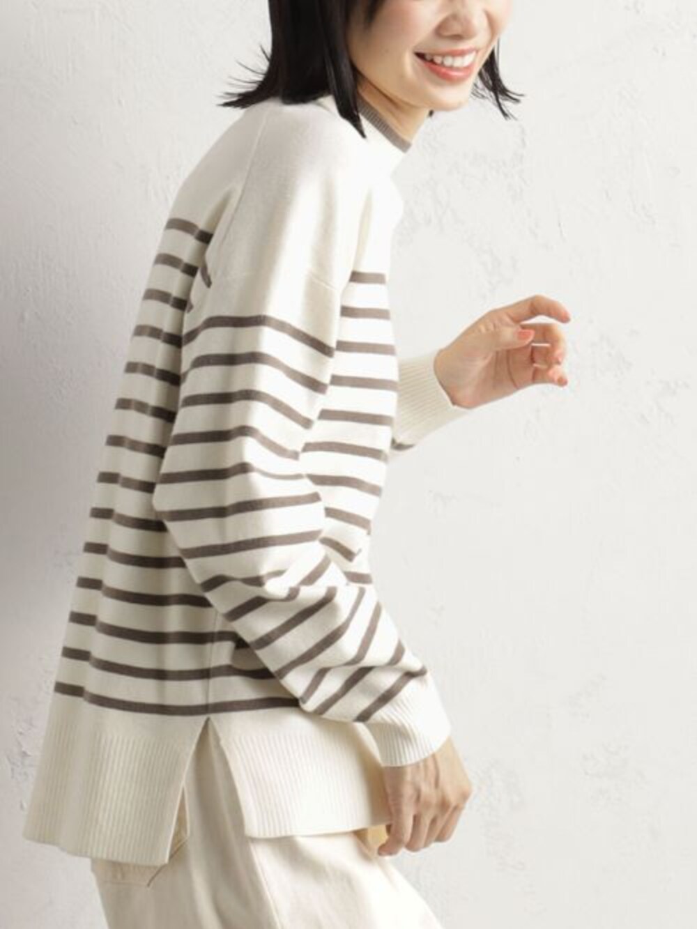 ブラウン系のブーツ、グレー系のニット/セーター、ホワイト系のその他パンツを着用したレディースの冬コーディネートの3枚目の写真