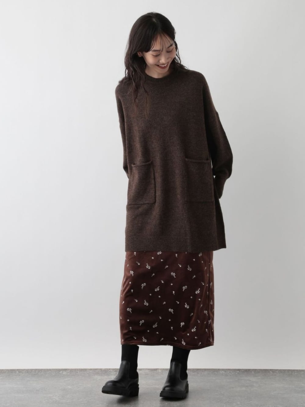 ブラウン系のニット/セーターを着用したレディースの冬コーディネートの2枚目の写真