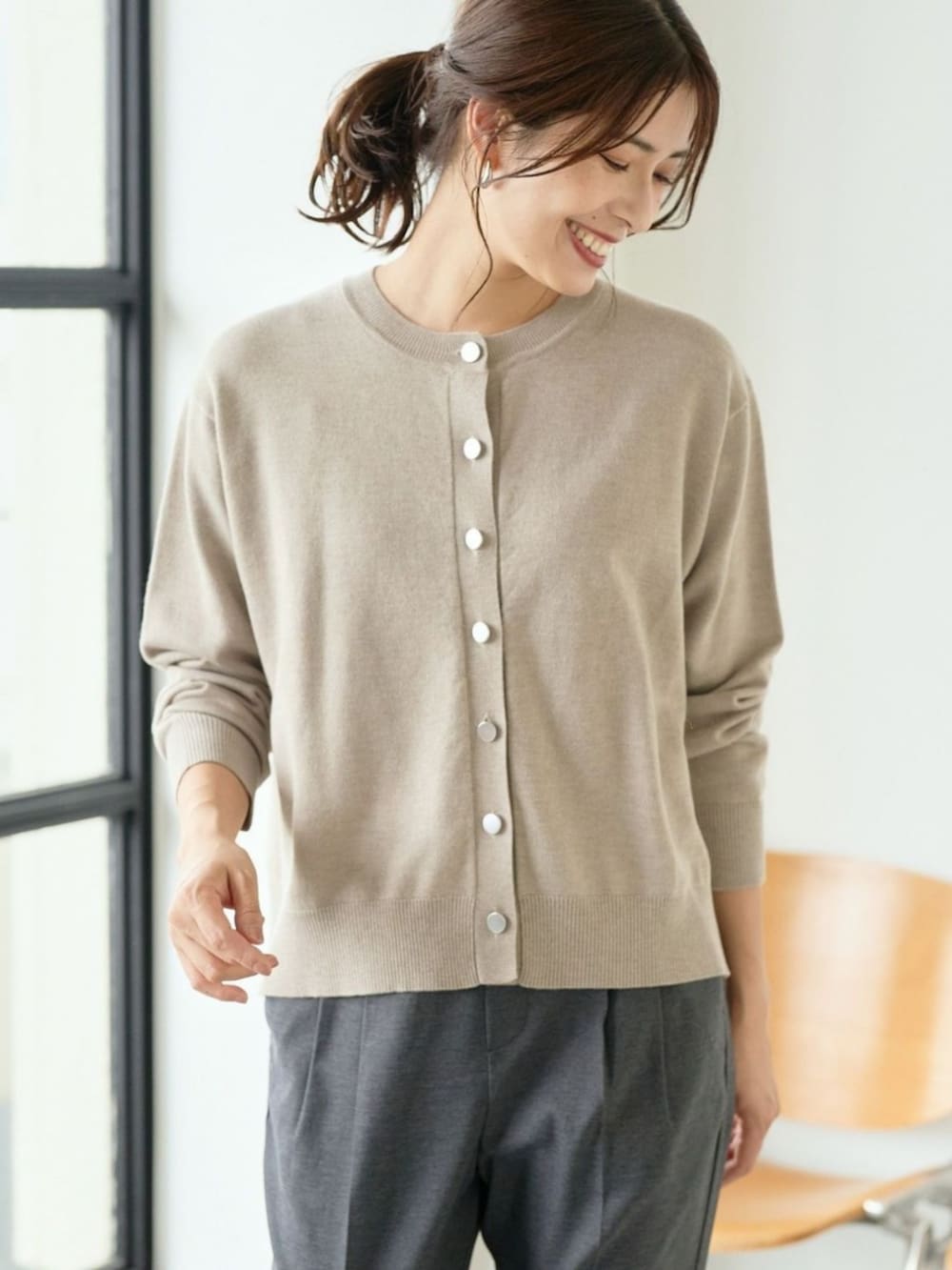 ベージュ系のカーディガン/ボレロを着用したレディースの冬コーディネートの2枚目の写真