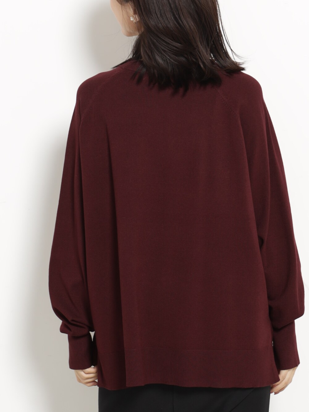 ブラック系のショルダーバッグ、レッド系のニット/セーター、ブラック系のスカートを着用したレディースの秋コーディネートの3枚目の写真