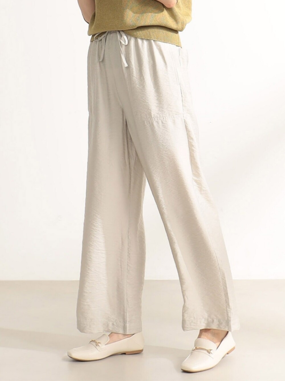 ベージュ系のその他パンツを着用したレディースの夏コーディネートの2枚目の写真