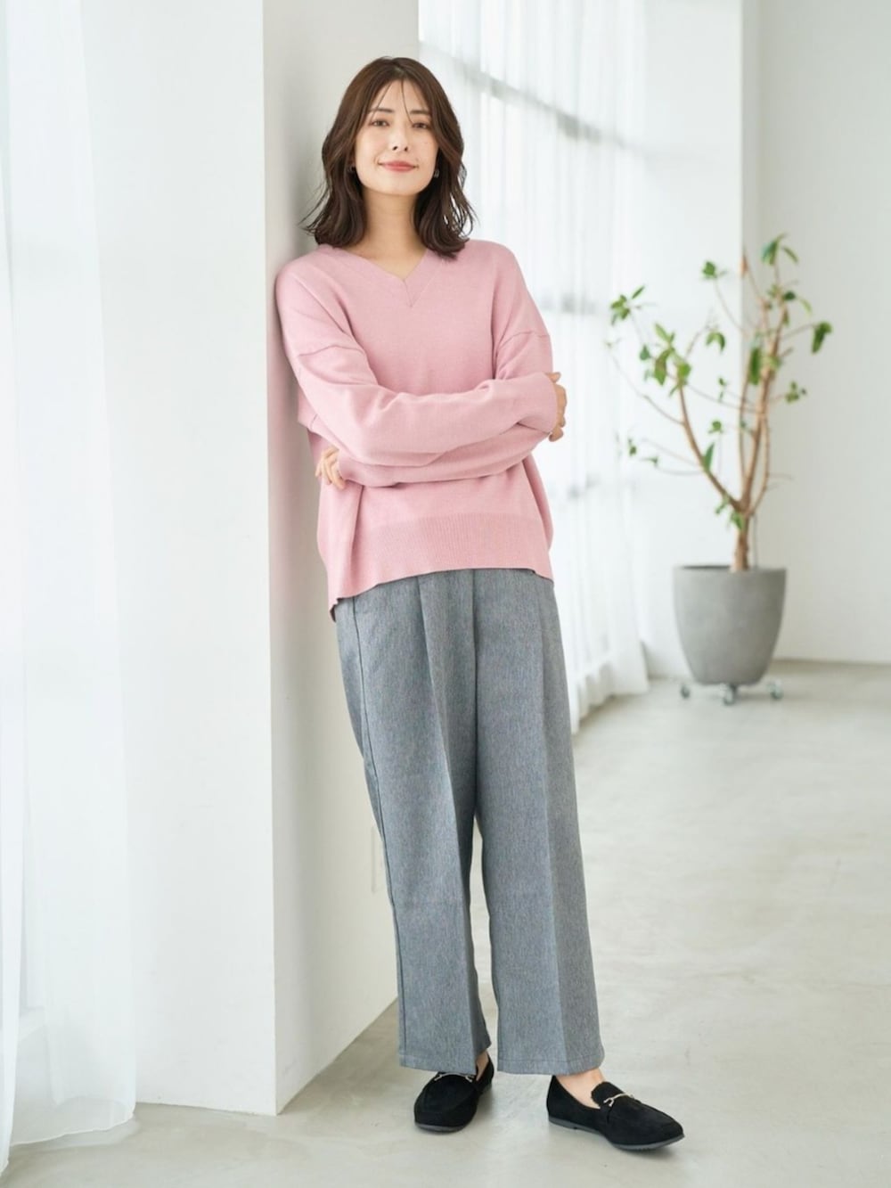 ピンク系のニット/セーターを着用したレディースの冬コーディネートの2枚目の写真