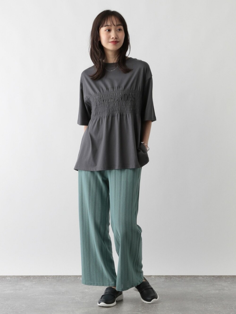 グレー系のTシャツ/カットソーを着用したレディースの秋コーディネートの2枚目の写真