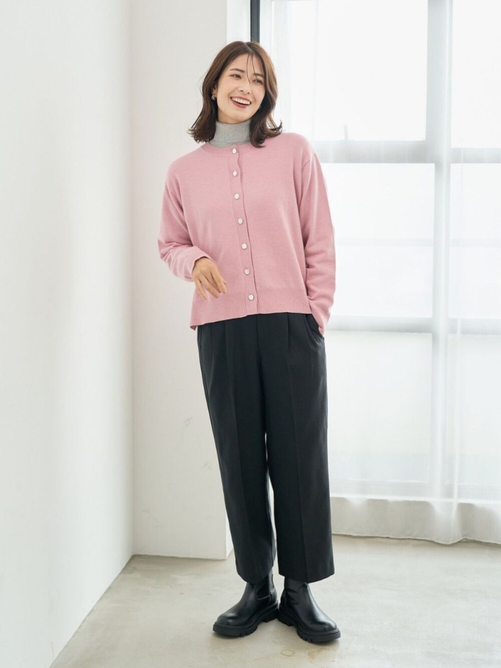 ピンク系のカーディガン/ボレロを着用したレディースの冬コーディネートの2枚目の写真
