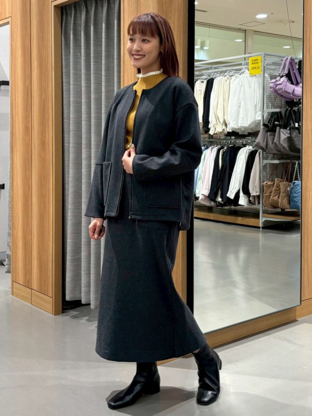 ブラック系のブルゾン、ブラック系のスカートを着用したレディースの冬コーディネートの2枚目の写真