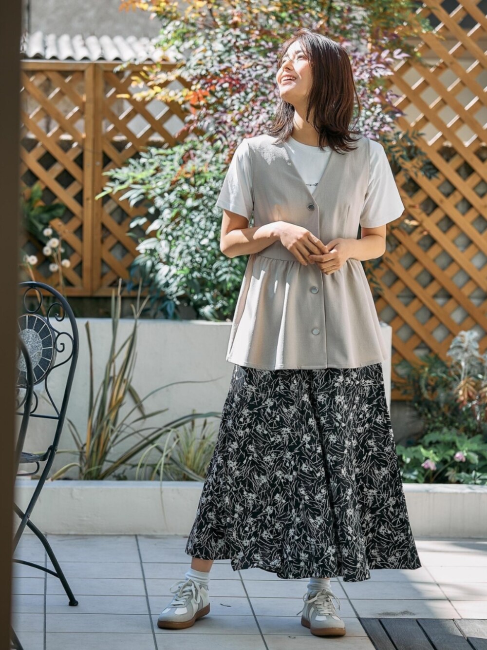 ベージュ系のベストを着用したレディースの夏コーディネートの2枚目の写真