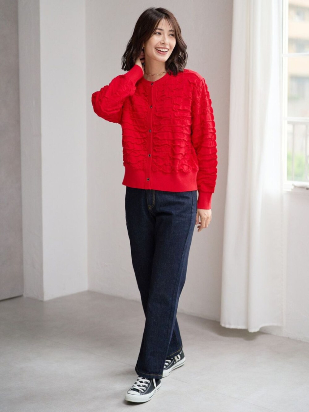 レッド系のカーディガン/ボレロを着用したレディースの秋コーディネートの2枚目の写真