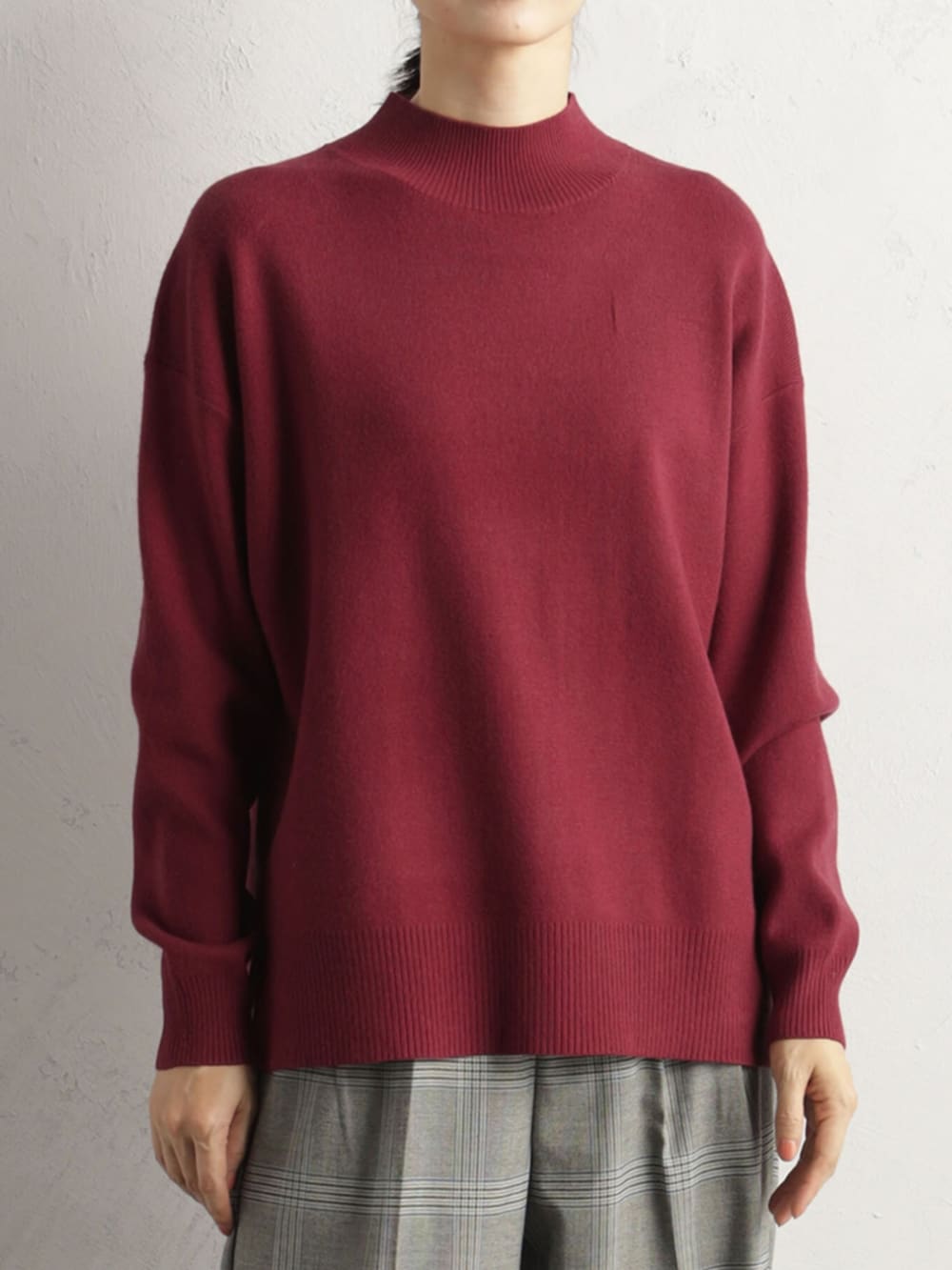 レッド系のニット/セーターを着用したレディースの冬コーディネートの2枚目の写真