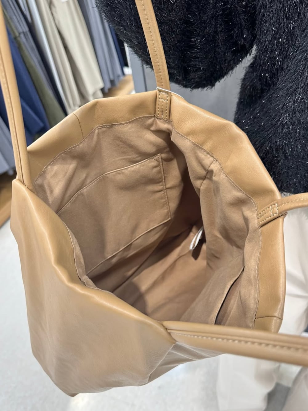 ベージュ系のトートバッグを着用したレディースの冬コーディネートの3枚目の写真