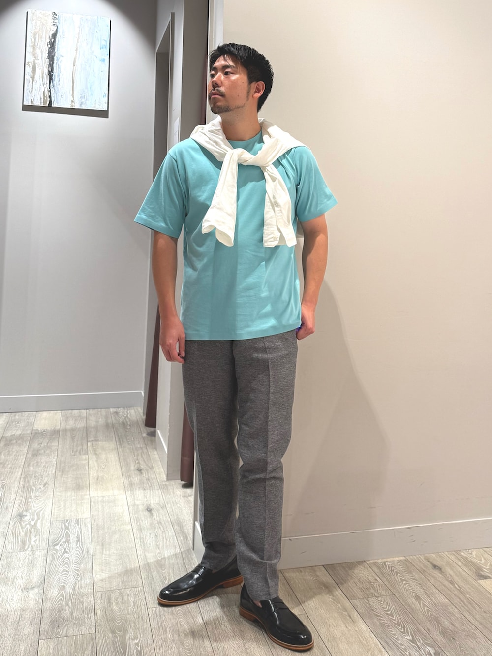 ホワイト系のシャツ/ブラウス、グリーン系のTシャツ/カットソー、グレー系のスラックスを着用したメンズの夏コーディネートの4枚目の写真