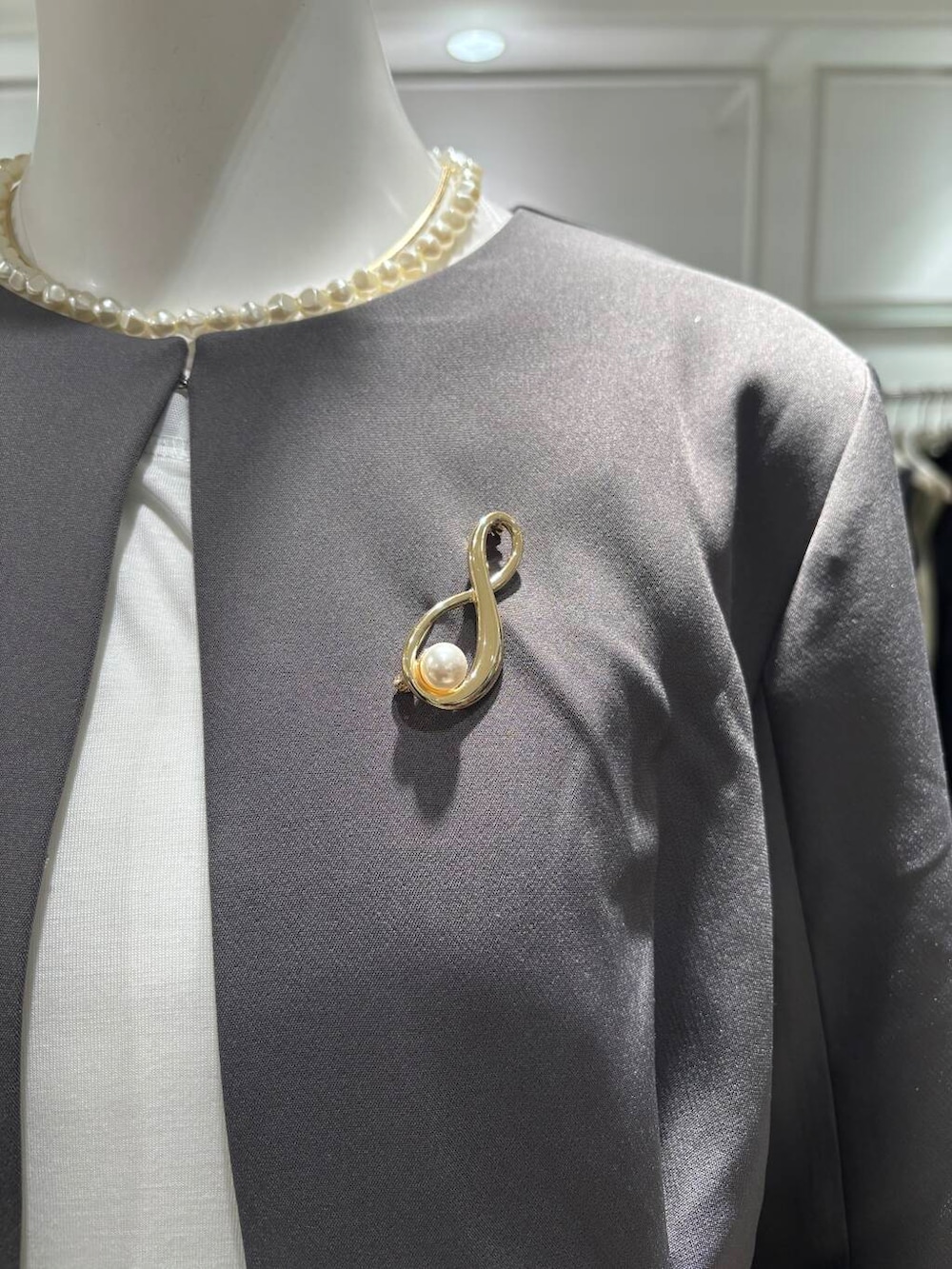 ブラック系のハンドバッグ、ブラック系のTシャツ/カットソー、ブラック系のパンプスを着用したレディースの冬コーディネートの6枚目の写真