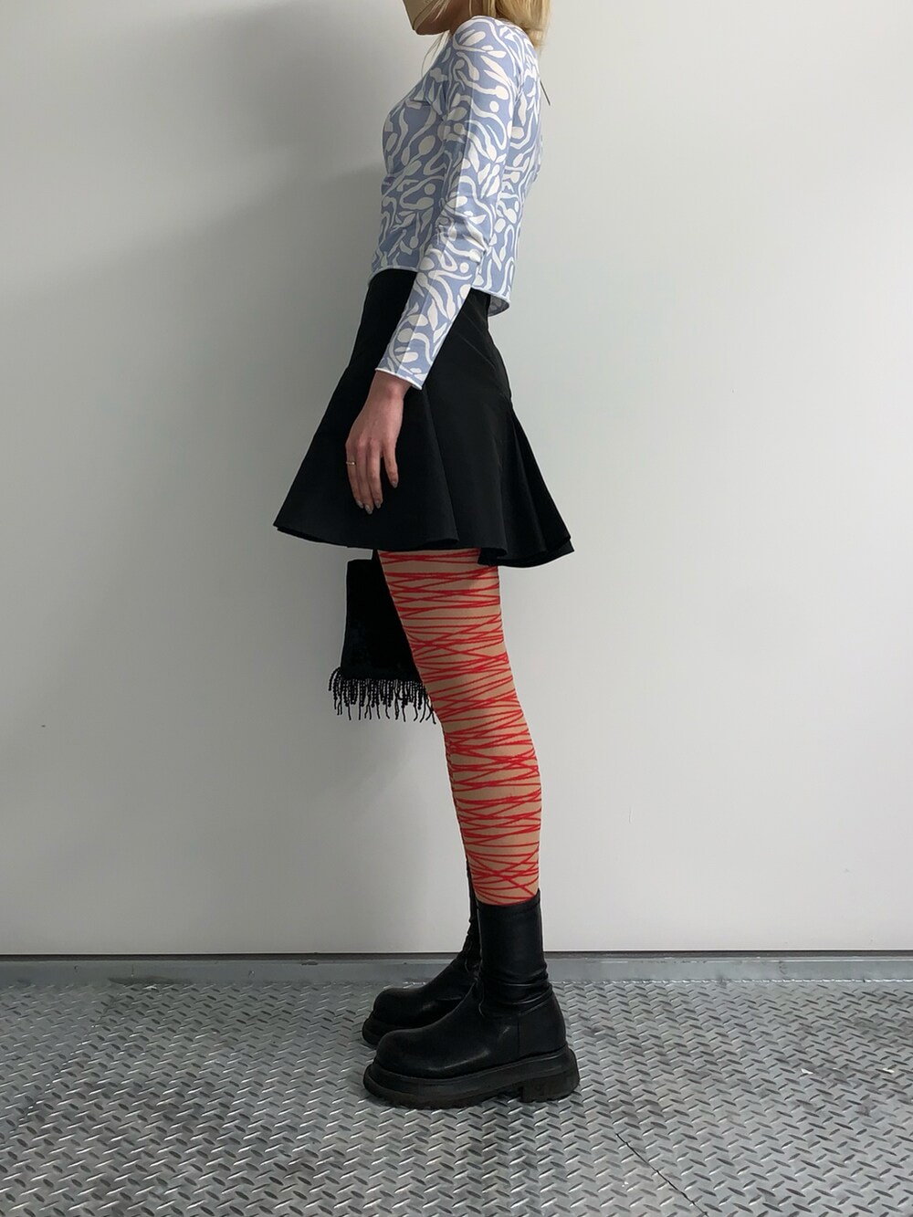 ブルー系のTシャツ/カットソー、ブラック系のハンドバッグ、シルバー系のネックレスを着用したレディースの春コーディネートの2枚目の写真