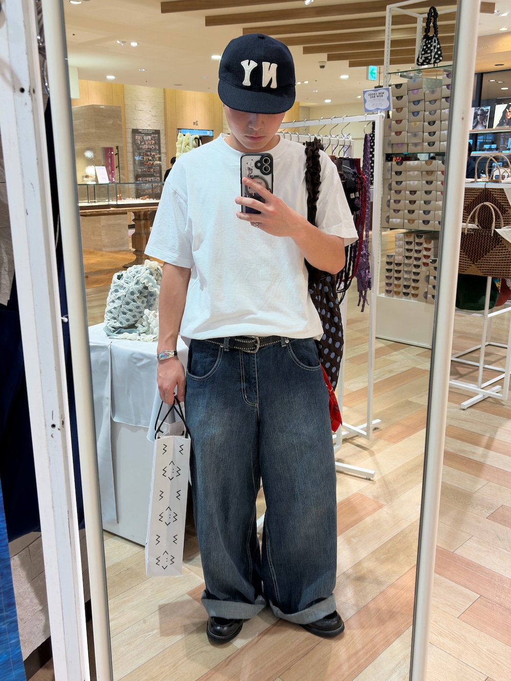 ホワイト系のTシャツ/カットソー、ブルー系のデニムパンツ、ブラック系のローファーを着用したメンズの夏コーディネートの2枚目の写真