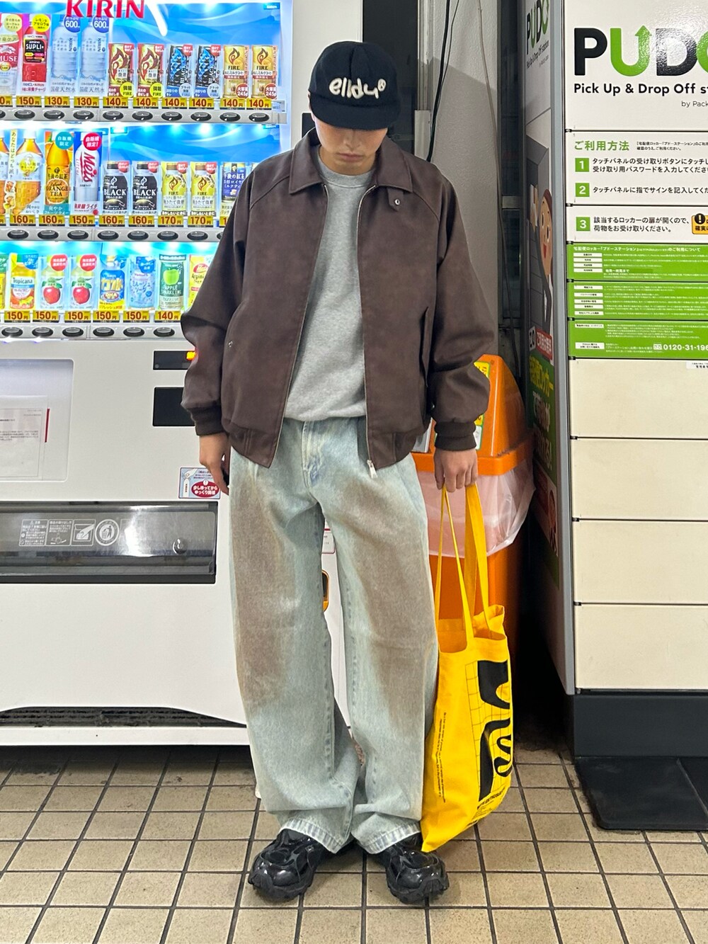 ブラウン系のブルゾン、ブルー系のデニムパンツ、グレー系のスウェットを着用したメンズの秋コーディネートの2枚目の写真