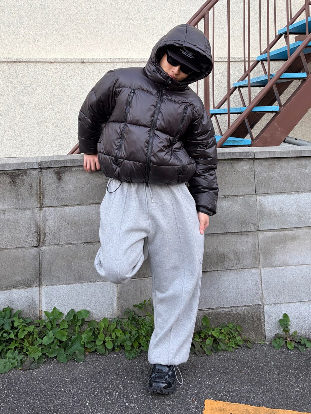 ブラック系のダウンジャケット/コート、グレー系のスウェットパンツ、ブラック系のスニーカーを着用したメンズの冬コーディネートの2枚目の写真