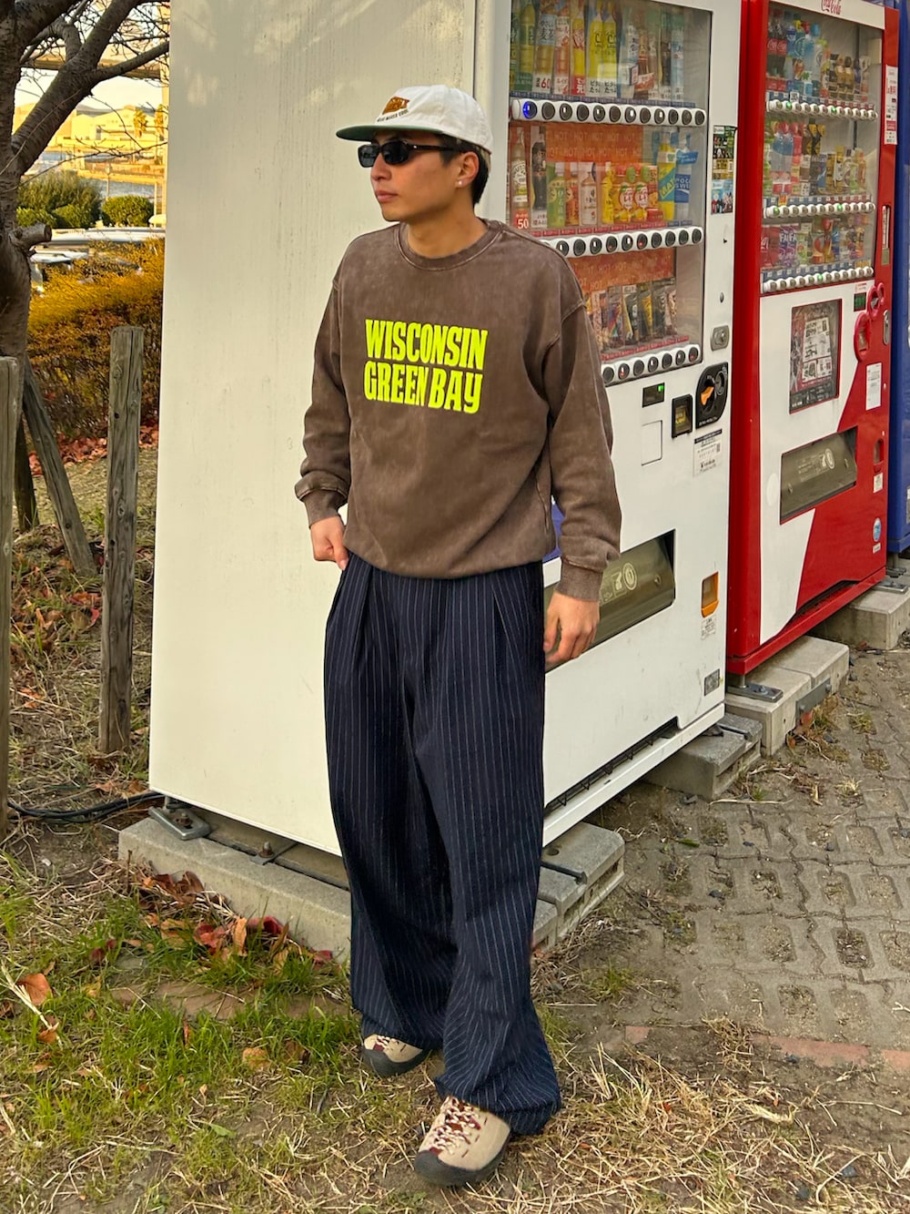 ブラウン系のスウェット、ブルー系のスラックス、ベージュ系のスニーカーを着用したメンズの冬コーディネートの2枚目の写真