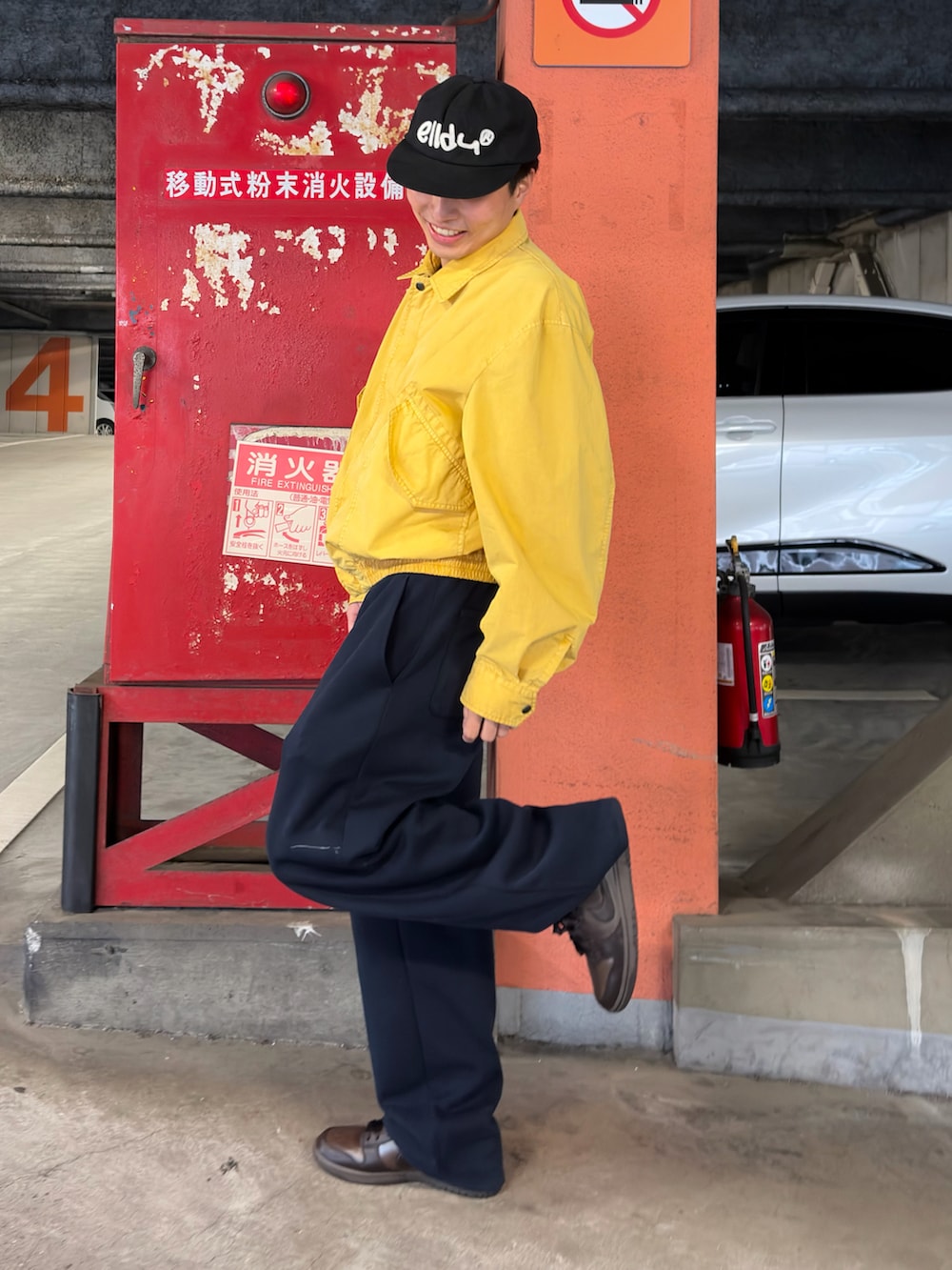 ブラウン系のスニーカー、イエロー系のミリタリージャケット、ブルー系のスウェットパンツを着用したメンズの春コーディネートの2枚目の写真