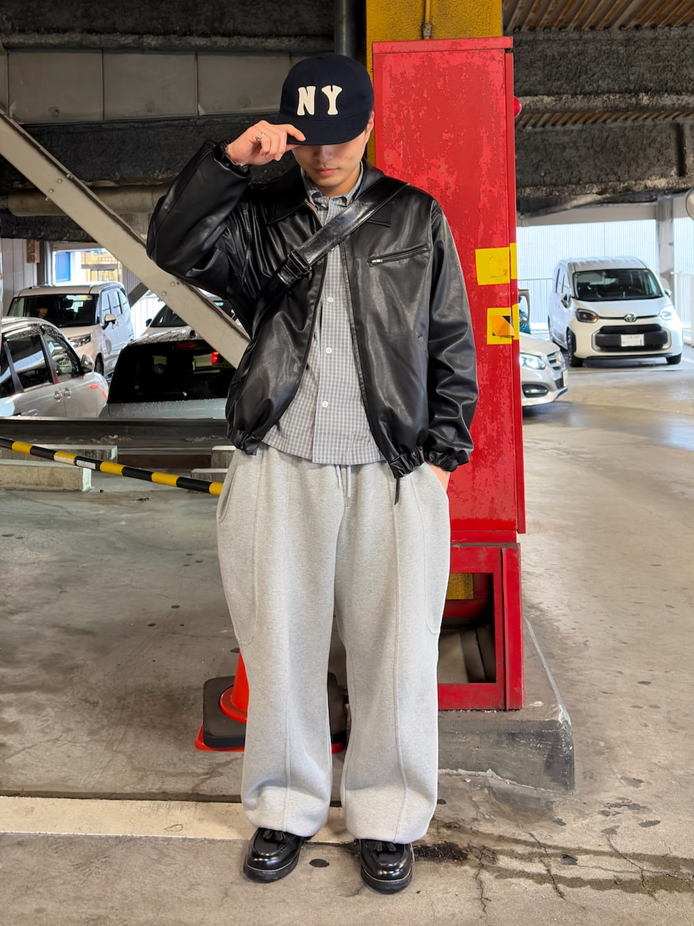 グレー系のスウェットパンツ、ブラック系のブルゾン、ブラック系のローファーを着用したメンズの春コーディネートの2枚目の写真