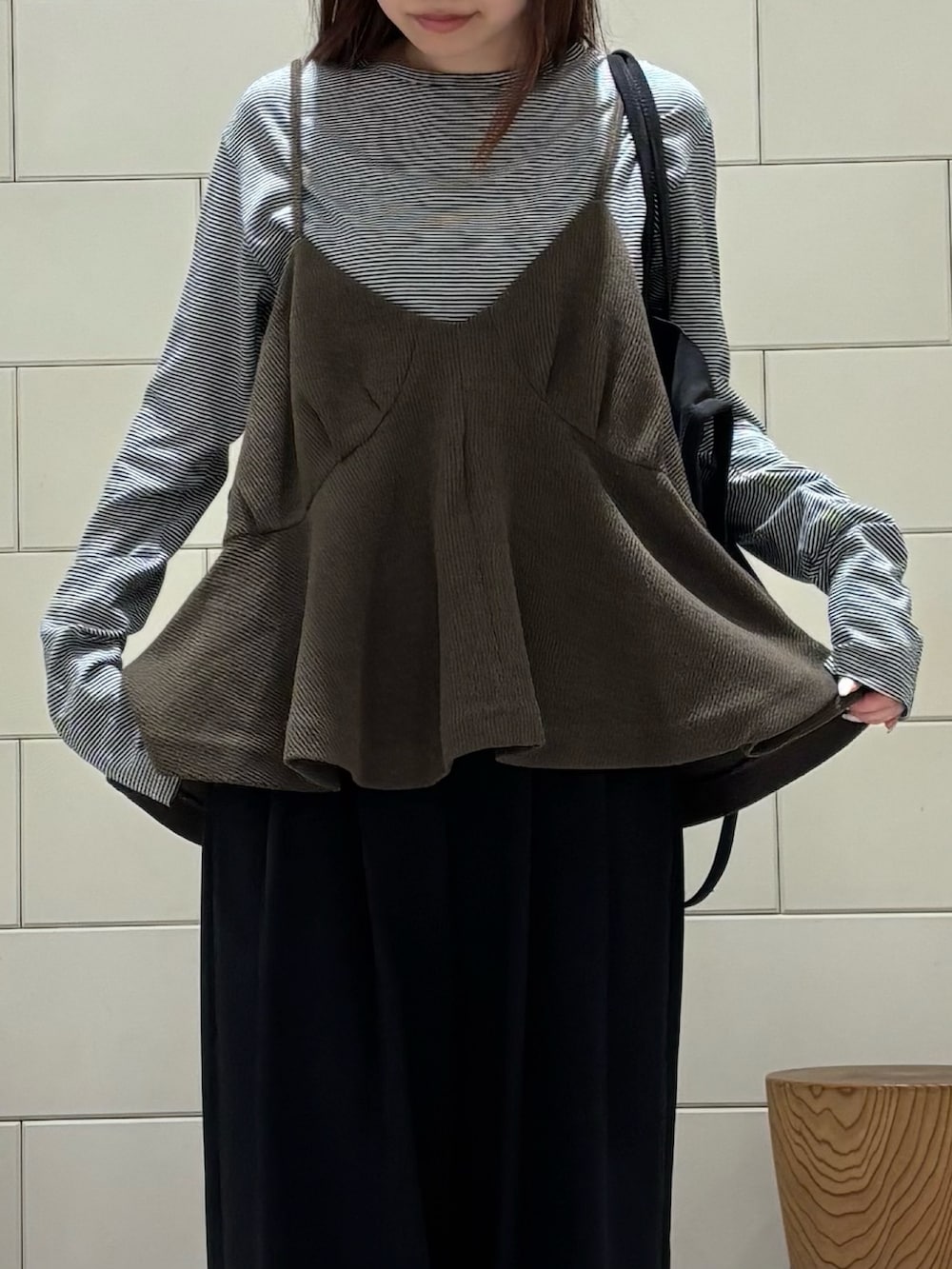 ブラック系のTシャツ/カットソー、ブラック系のその他パンツ、グリーン系のトートバッグを着用したレディースの秋コーディネートの4枚目の写真