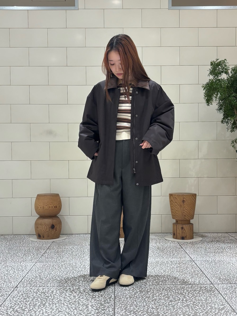 ブラウン系のダウンジャケット/コート、グレー系のその他パンツ、ベージュ系のスニーカーを着用したレディースの冬コーディネートの2枚目の写真